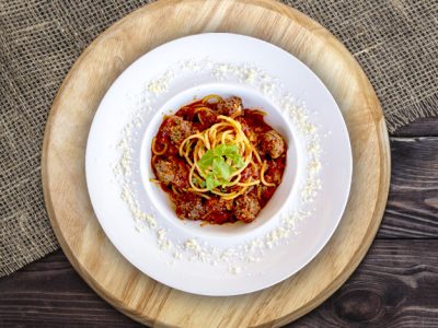 Round cutting board on dark wooden table, top view
